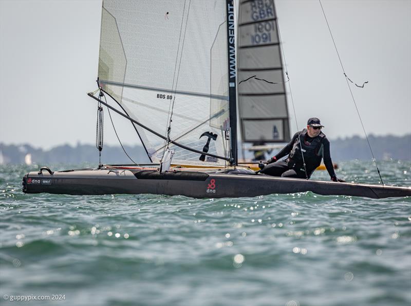 Ben Daignault in full low drag, downwind mode on his DNA F1x during the Unicorn and A Class Catamaran Nationals at Hayling Ferry SC photo copyright Gordon Upton / www.guppypix.com taken at Hayling Ferry Sailing Club and featuring the A Class Catamaran class