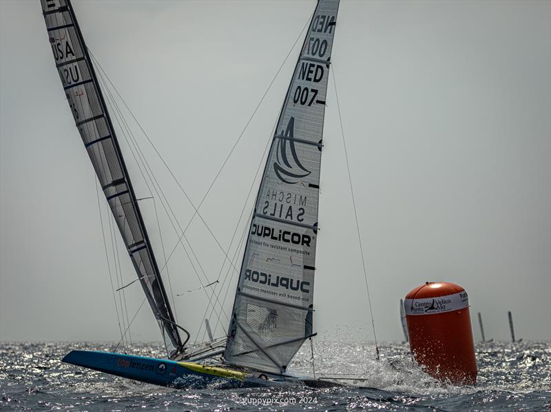 A Class Cat Regata Nazionale - Ravi Parent USA 76 and Mischa Heemskerk NED 007 tussle at the downwind mark on race one photo copyright Gordon Upton / www.guppypix.com taken at Centro Velico Punta Ala and featuring the A Class Catamaran class