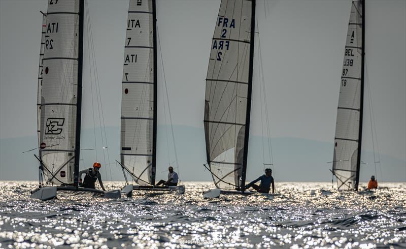 A Class Cat Regata Nazionale - How to identify the categories in a mixed fleet. Open (foiling) category: no red dot, Classic : big red dot. It works very well as we see here - photo © Gordon Upton / www.guppypix.com