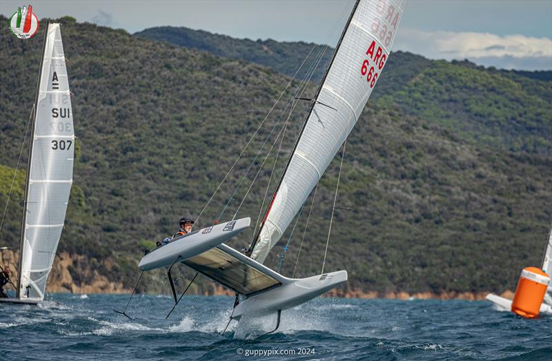 A Class Cat Worlds at Punta Ala - Ian Rodger, ARG 666, appears totally unconcerned that his boat is rather loose at the top mark in 22 kts - photo © Gordon Upton / www.guppypix.com