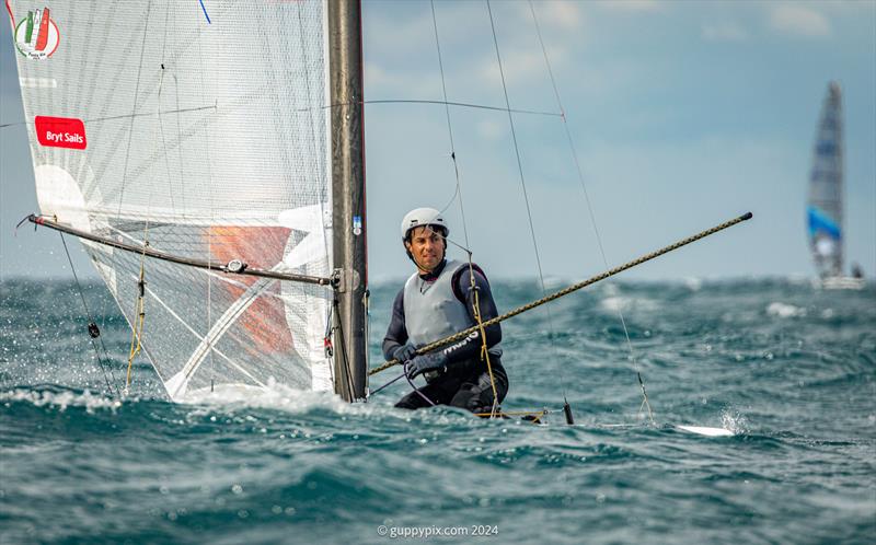 A Class Cat Worlds at Punta Ala - Kuba Surowiec, POL, crosses the line in a masterclass demo of high wind A-Cat foil sailing to win his second and consecutive Open World Championship photo copyright Gordon Upton / www.guppypix.com taken at Centro Velico Punta Ala and featuring the A Class Catamaran class