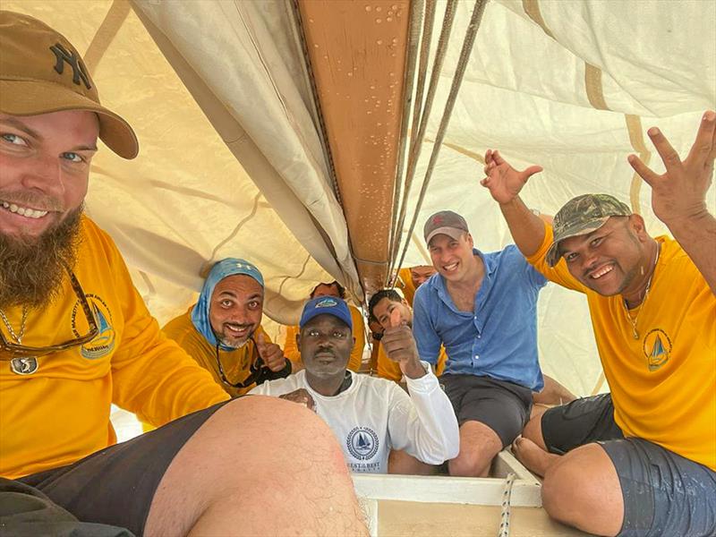 Getting out of the rain: Prince William, Duke of Cambridge, under the mainsail with the crew of Bahamian Sloop Susan Chase V after winning the Royal Regatta. L-R: Travis Knowles, Ceri, Security, Claudius, Garret, CJ, William (Duke), Stefan Knowles photo copyright Travis Knowles taken at Nassau Yacht Club and featuring the Classic Yachts class