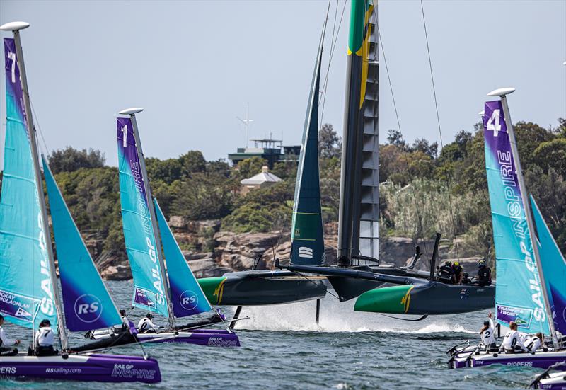 Australia SailGP Team helmed by Tom Slingsby sails close to young sailors in the SailGP Inspire program as they warm up before racing on Race Day 1.- SailGP - Sydney - Season 2 - February 2020 - Sydney, Australia photo copyright Craig Greenhill/SailGP taken at Royal Sydney Yacht Squadron and featuring the F50 class