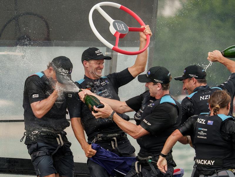 The New Zealand SailGP Team crew spray each other with Champagne Barons de Rothschild on board their F50 after winning the final race on Race Day 2 of the Singapore Sail Grand Prix photo copyright Bob Martin/SailGP taken at Singapore Yacht Club and featuring the F50 class