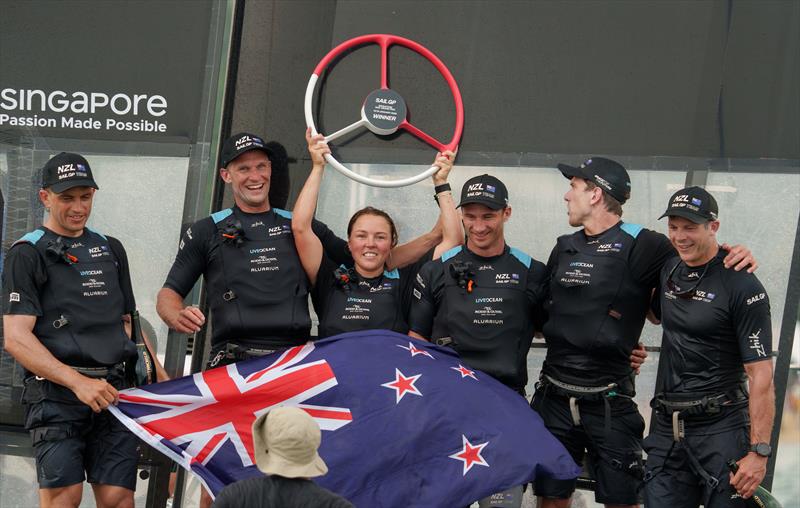 Liv Mackay, strategist of New Zealand SailGP Team, holds the trophy aloft after winning the final race on Race Day 2 of the Singapore Sail Grand Prix photo copyright Bob Martin/SailGP taken at Singapore Yacht Club and featuring the F50 class