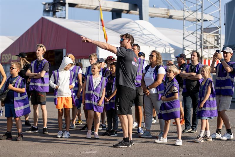 Martin Kirketerp, grinder of Denmark SailGP Team, gives guests of the SailGP Inspire program a tour of the Technical Base ahead of Rockwell Denmark Sail Grand Prix in Copenhagen, Denmark photo copyright Felix Diemer / SailGP taken at Royal Danish Yacht Club and featuring the F50 class