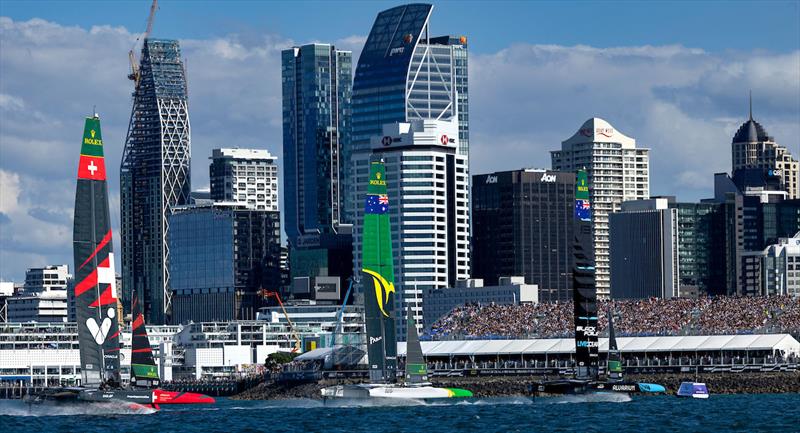 Switzerland SailGP Team helmed by Sebastien Schneiter, Australia SailGP Team helmed by Tom Slingsby and New Zealand SailGP Team helmed by Peter Burling sail past spectators in the grandstand on Race Day 1 photo copyright Felix Diemer for SailGP taken at Auckland Sailing Club and featuring the F50 class