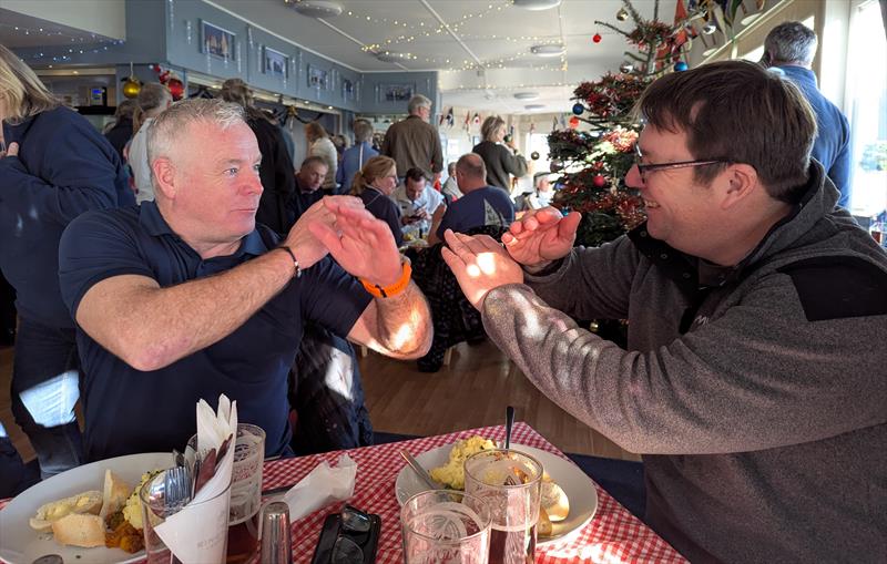 Finn sailors Cy Grisley and Simon Moss karate sailing over a shepherd's pie after the Keyhaven Yacht Club Rum Race - photo © Mark Jardine