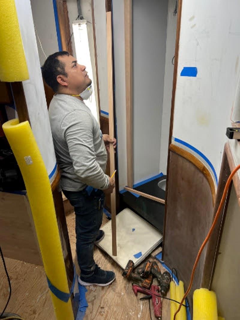 Hull #7 - Emilio on washer/dryer installation - photo © Michael Rybovich & Sons