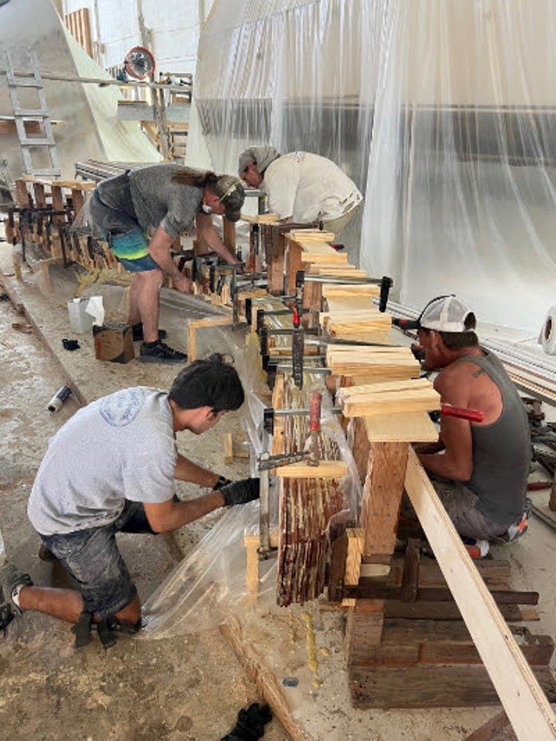 Hull #10 - Hank, Flipper and Scotty gluing up the stem - photo © Michael Rybovich & Sons