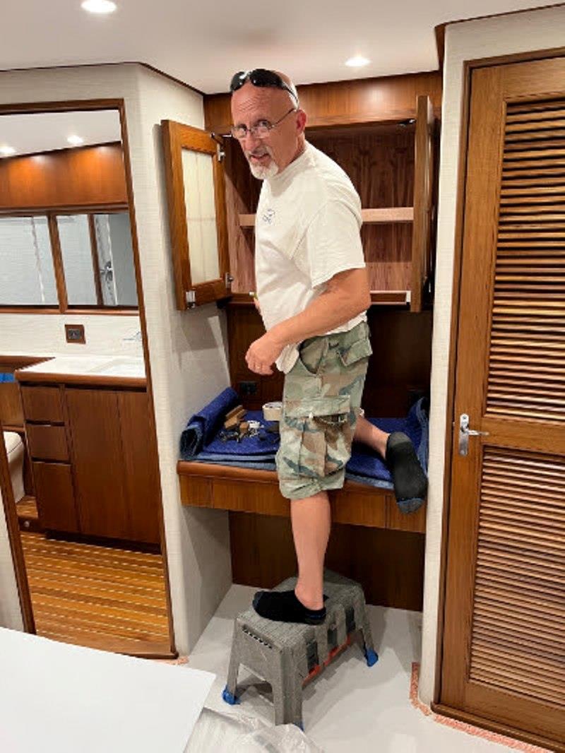 Hull #7 - Mario installing cabinet hardware - photo © Michael Rybovich & Sons
