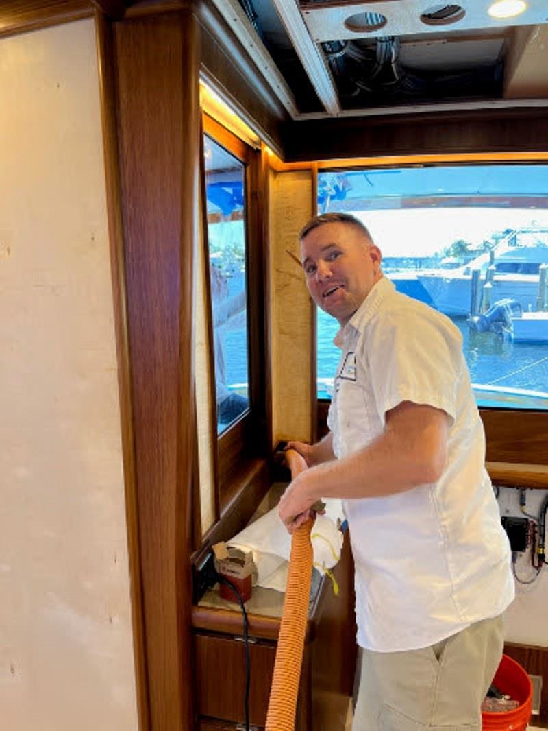 Hull #7 - Thomas installing salon lambrequins - photo © Michael Rybovich & Sons