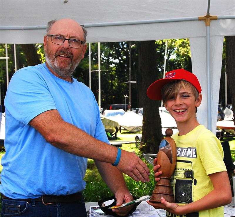 MYA Footy National Championship at Frensham Pond - Oliver Stollery being presented with trophy and prize by Class Captain, Peter Shepherd photo copyright Roger Stollery taken at Frensham Pond Sailing Club and featuring the Footy class