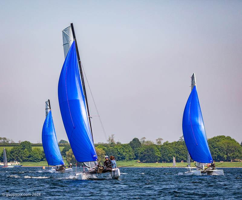 Nick Barnes' F18 races Will Smith and the Nacra 15 for the finish during the Rutland Cat Open 2024 photo copyright Gordon Upton / www.guppypix.com taken at Rutland Sailing Club and featuring the Formula 18 class