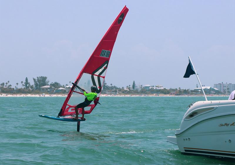 Justin Ahearn finishes a race photo copyright Britt Viehman taken at New York Yacht Club and featuring the iQFoil class