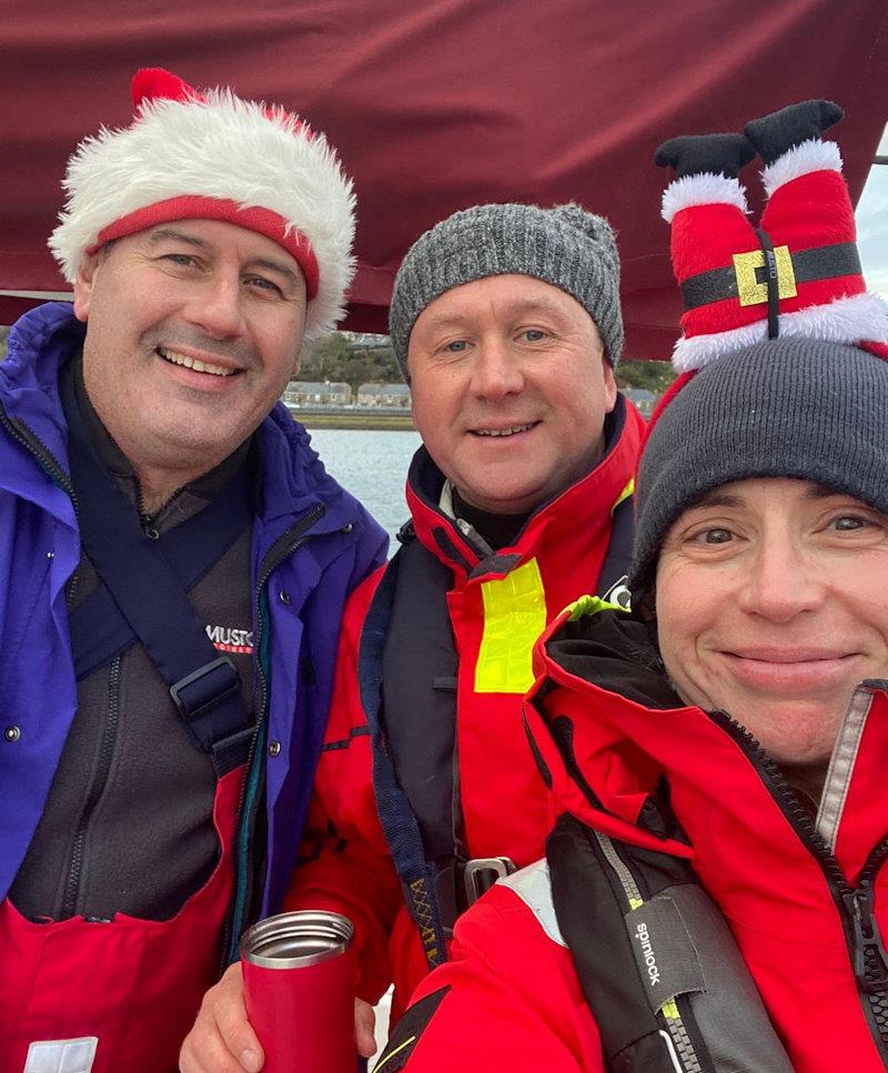 Santa hats on and mulled wine to warm the crew of Finally at the finish of the Pwllheli Santa Special photo copyright Sioned Owen taken at Pwllheli Sailing Club and featuring the IRC class