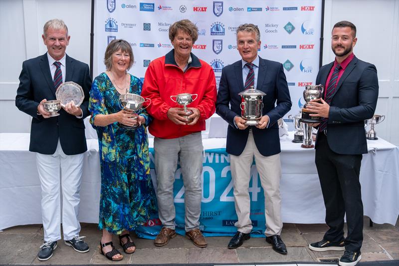 Stephen Herring, Mel Lewis, David Harris and Ralph Herring are helped by the RBYC's Commodore David Smith to present the trophies won during Burnham Week 2024 photo copyright Petru Balau Sports Photography / sports.hub47.com taken at Royal Corinthian Yacht Club, Burnham and featuring the IRC class