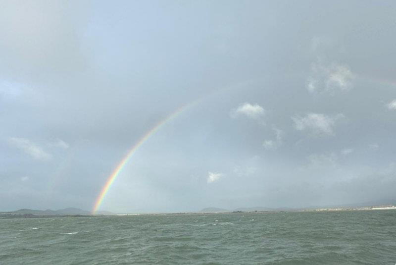 Showers provided a rainbow backdrop - Pwllheli SC Santa Special photo copyright Hannah Entwistle taken at Pwllheli Sailing Club and featuring the IRC class