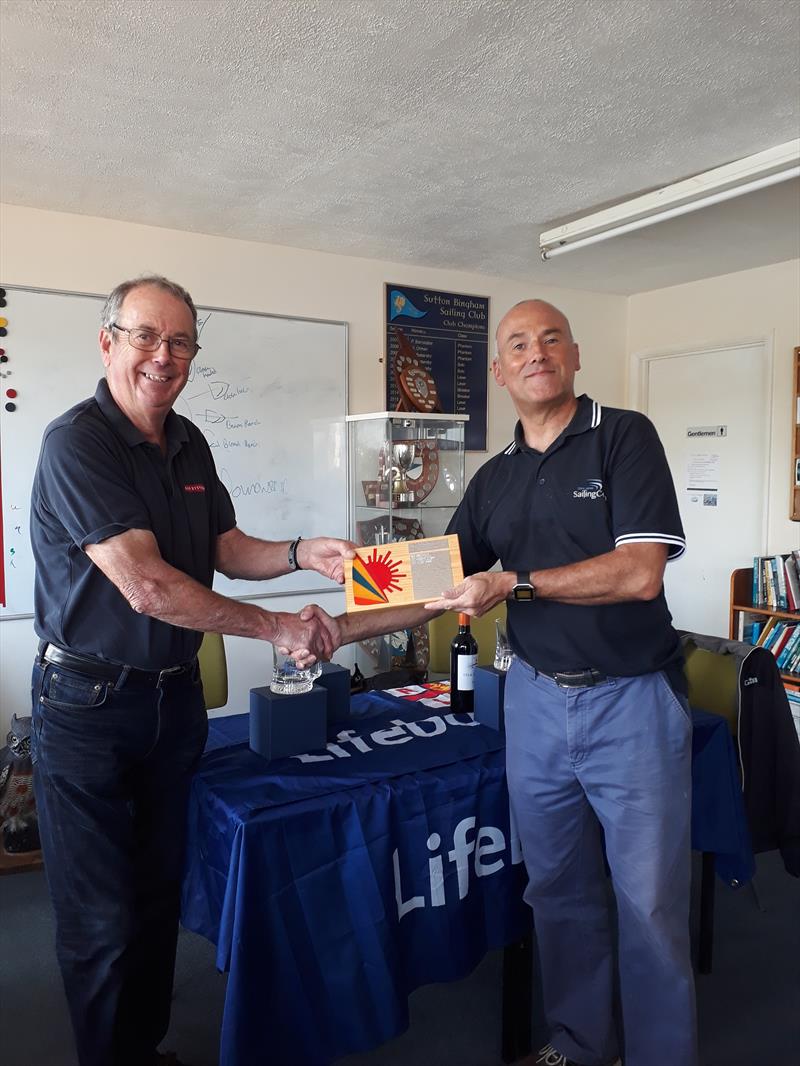 Mervyn Clark awards the Laser Radial fleet trophy to Chris Jones during the Sutton Bingham Laser GP photo copyright Saffron Gallagher taken at Sutton Bingham Sailing Club and featuring the ILCA 6 class