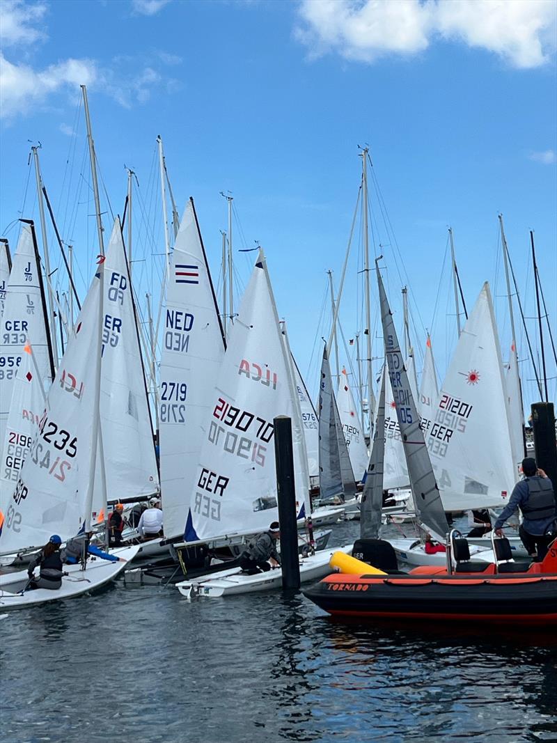 An on-water traffic jam on Saturday during Kieler Woche when five fleets are released to launch at once photo copyright Martin Pascoe taken at Kieler Yacht Club and featuring the ILCA 6 class