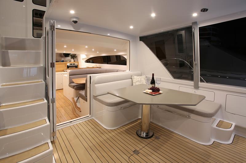 Cockpit, exterior mid-pilothouse stairs, exterior dinette. Note: the window between the dinettes is electrically actuated with the bi-fold cockpit doors sealing directly against the glass when in the cl - Zaphira - 18m Elite - Lloyd Stevenson Boatbuilders photo copyright Bryce Taylor. taken at Bucklands Beach Yacht Club and featuring the  class