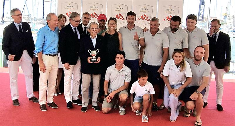 Adriano Calvini with grandson Giovanni Chiappano (in red cap), Rolex Italia's Stefan Müller to his left and, far left, Yacht Club Italiano President Gerolamo Bianchi photo copyright James Boyd / IMA taken at Yacht Club Italiano and featuring the Maxi class
