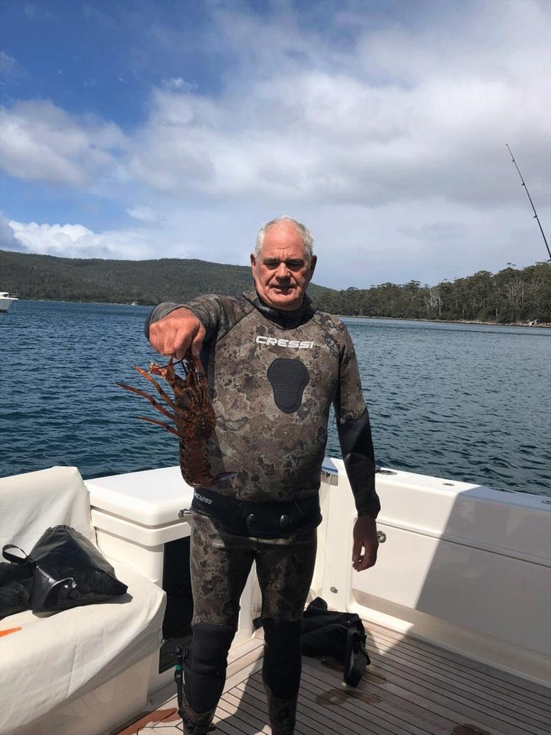 Skipper-cum-diver David Prior with some of the local natural bounty he caught, a fresh Tasmanian lobster. - photo © Riviera Australia