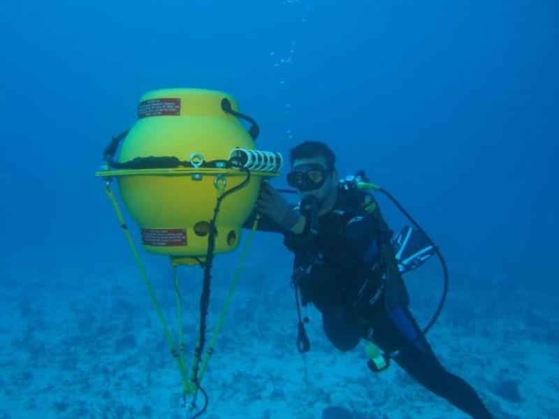 Jeremy Kiszka of Florida International University checks on one of the Marine Autonomous Recording Units (MARUs) deployed in the Caribbean in 2017 to record humpback songs and other ocean sounds. - photo © NOAA Fisheries