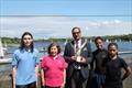 Brent Regatta 2024: A moment of sunshine, the regatta in the background. Junior Instructor Nico, Social Secretary Vivien, Mayor of Brent Tariq Dar, Juniors Alex & Zach © Anita Whittaker, Welsh Harp Sailing Club