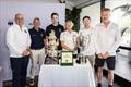 The panelists standing around the Overall winner trophy, Rolex timepiece and Line Honours trophy (left to right). Panelists from left to right: Matt Allen, Peter Bremner, Sebastian Bohm, Wendy Tuck, Phillip Kurts and Christian Beck  © CYCA  | Andrea Francolini