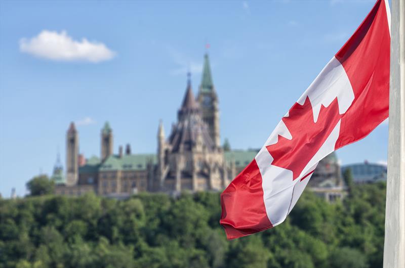 Canadian flag waving with Parliament Buildings hill and Library in the background - photo © National Marine Manufacturers Association