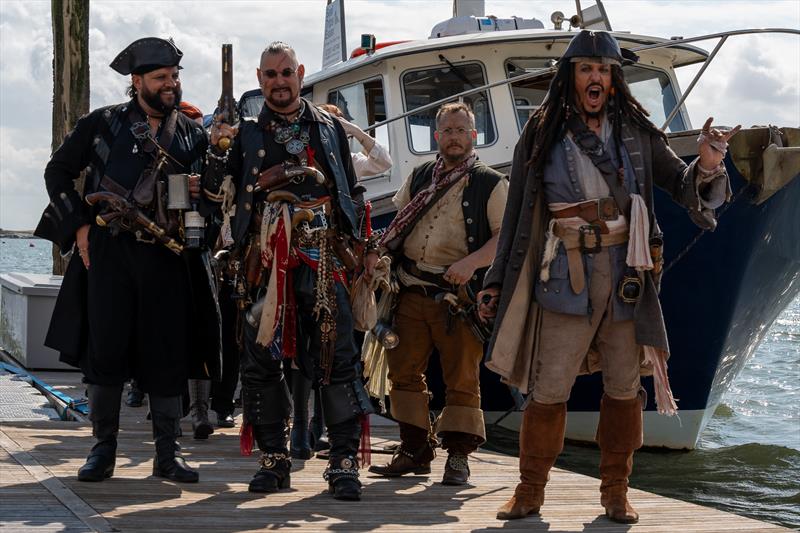 Pirates attack during Burnham Week 2024, with smiles and sea shanties photo copyright Petru Balau Sports Photography / sports.hub47.com taken at Royal Corinthian Yacht Club, Burnham