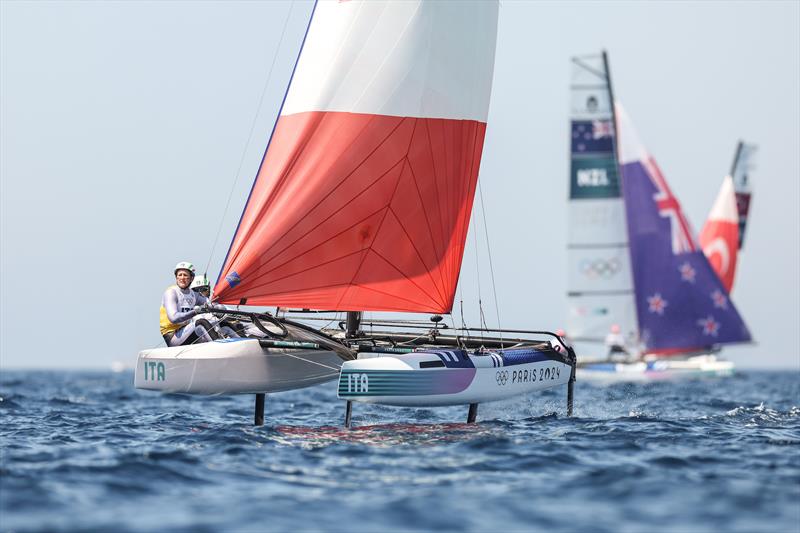 Micah Wilkinson & Erica Dawson (NZL) trail Ruggero Tita & Catarina Banti (ITA) - Mixed Multihull - Nacra17 - Paris 2024 - Marseille - August 6, 2024 - photo © World Sailing / Sander van der Borch