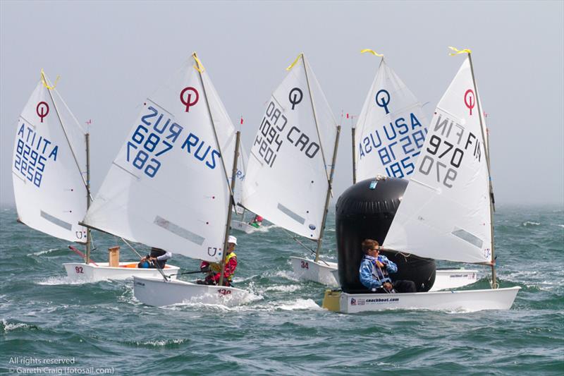 Racing on the fourth day of the Optimist European Championships on Dublin Bay photo copyright Gareth Craig / www.fotosail.com taken at Royal St George Yacht Club and featuring the Optimist class