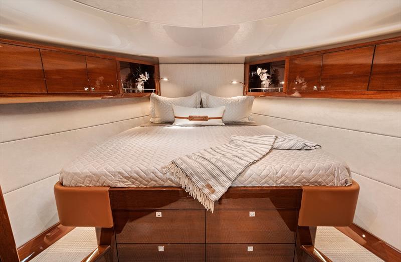 Forward accommodations include a beautifully appointed cabin with a king-size bed, bringing a level of comfort rarely associated with high-performance outboard yachts - photo © Palm Beach Motor Yachts