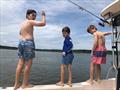 Fishing, swimming, and jumping off the side of the boat keeps the Troutman boys busy. 