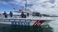 A crew from Marine Rescue Middle Harbour assists a disabled vessel