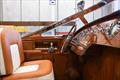 Marine leather, mahogany and the hand-cast, rose-polished steel windscreen meet at the helm