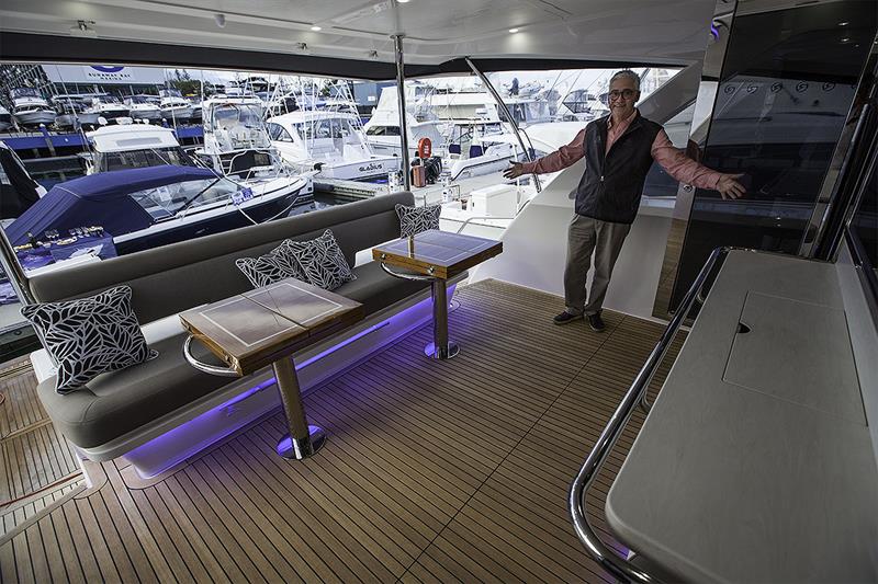 Stephen Milne, Brand & Communications Director, demonstrates where the extra room can be found on the mezzanine deck of the 72 Sports Motor Yacht photo copyright John Curnow taken at  and featuring the Power boat class