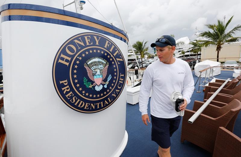 Christopher Hill, a deckhand, walks past a seal on the former presidential yacht, Honey Fitz, as it is docked in West Palm Beach, Florida photo copyright Reuters taken at  and featuring the Power boat class
