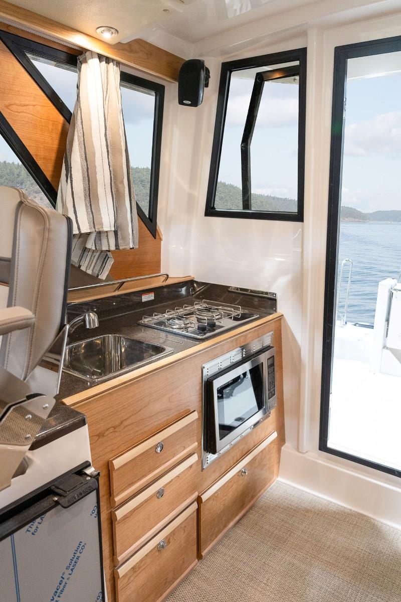 Extended stays aboard the C-288 C are made comfortable with a full galley featuring a propane stovetop, stainless steel sink and microwave/convection oven. - photo © Cutwater Boats