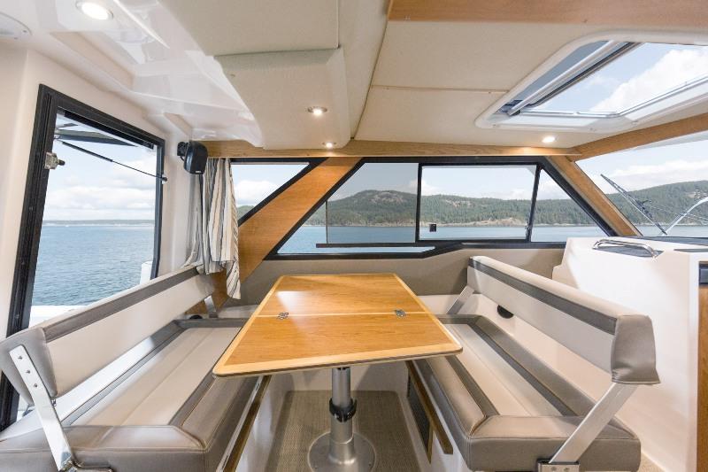 The convertible dinette features seating for four, an opening bulkhead seat and drops down for an additional berth. - photo © Cutwater Boats