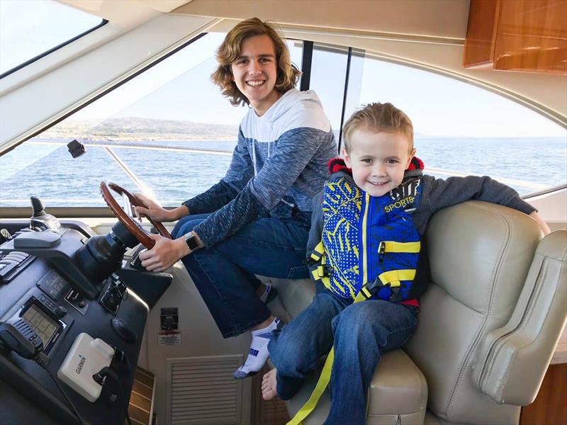 Ben on the helm with an excited Kellan photo copyright Riviera Australia taken at  and featuring the Power boat class