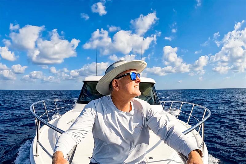 At one with the sea - Lance aboard Caroline 2.0 as they leave Grand Cayman Island in the Caribbean - photo © Riviera Australia