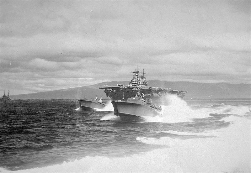 Two 77-foot Elco PT boats of MTBRON 1, PT-28 and PT-29, escort the aircraft carrier Hornet into Pearl Harbor upon her return from the Doolittle bombing raid on Tokyo, April 1942 - photo © National Archives