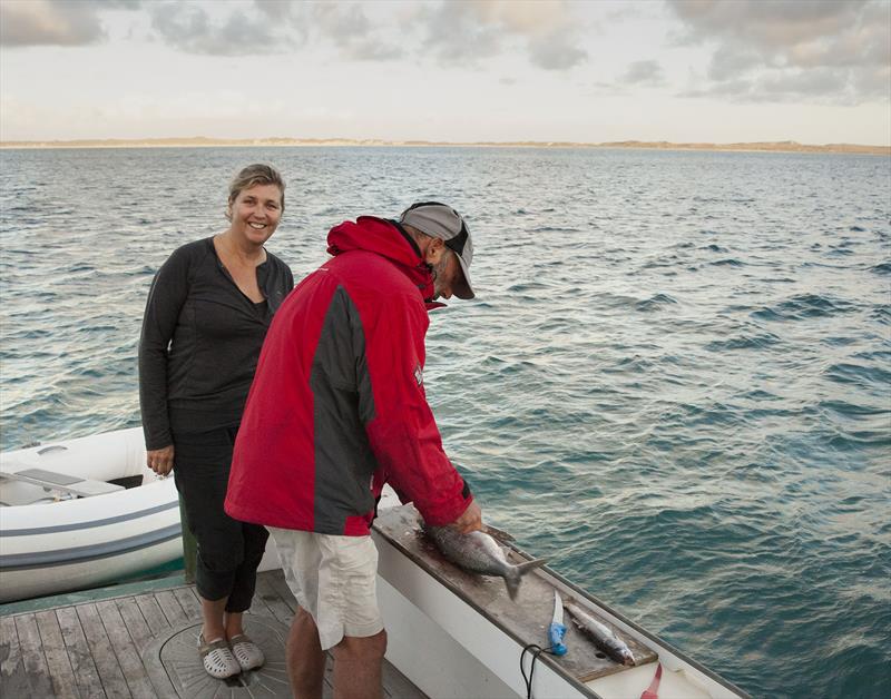 Fishing and seafood are a big feature of life afloat for Tim Phillips (seen here filleting) and the cruise-in-company - photo © The Wooden Boatshop