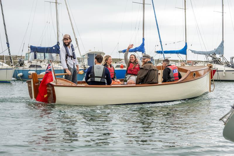 Boat Building Academy students launch their boats in Lyme Regis