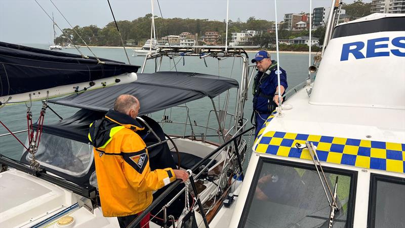 Port Stephens crew member with rescued sailor photo copyright Marine Rescue NSW  taken at  and featuring the Power boat class
