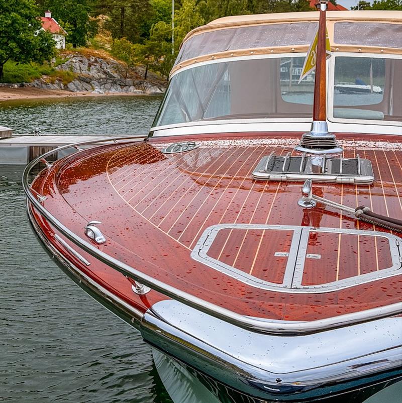 Mahogany foredeck, freshly varnished and beaded with rain - photo © J Craft Boats