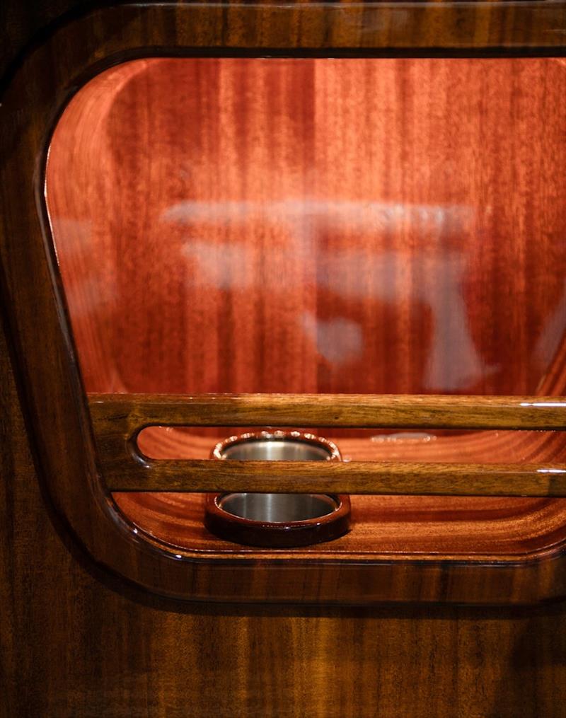 Stainless drinks holders recessed into the hand-worked mahogany - photo © J Craft Boats